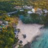 a beach with houses and trees