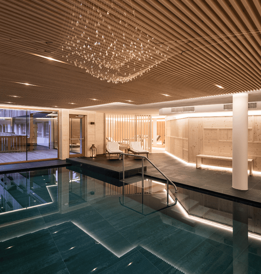 Luxury wellness retreat 2025 - The Ranch Malibu indoor spa pool with modern design, wooden ceiling, and relaxation areas for intensive transformation programs